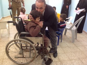 The director of the Cerebral Palsy Center greets one of the children. 