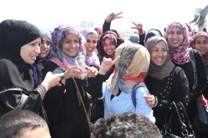 A group of young women give a warm welcome to the delegation.