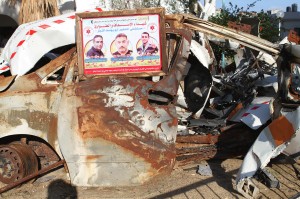 Photos of those who were recently killed by Israeli attacks are posted on cars and the rubble of buildings.