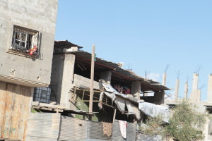 People living in their bombed home. (Photo by Bob Haynes)