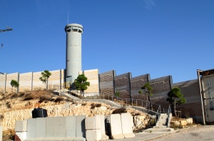 Armed guard towers and walls - yet some walk around them to work.