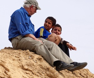 Bob Haynes on a sand hill, talking with local children (photo by Gerri Haynes)